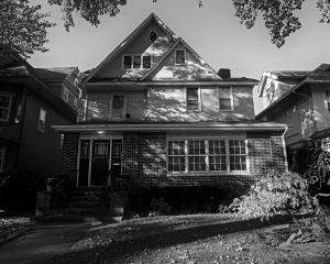 Timeless black and white photo of a suburban New York house with classic architectural details.
