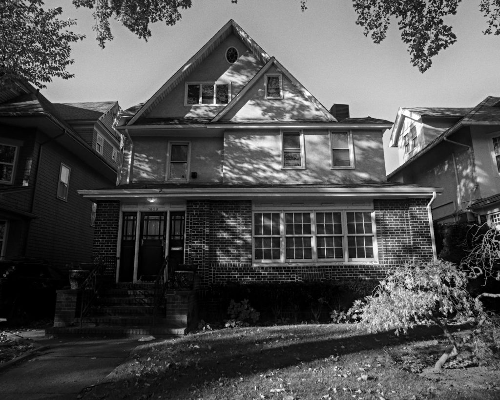 Timeless black and white photo of a suburban New York house with classic architectural details.