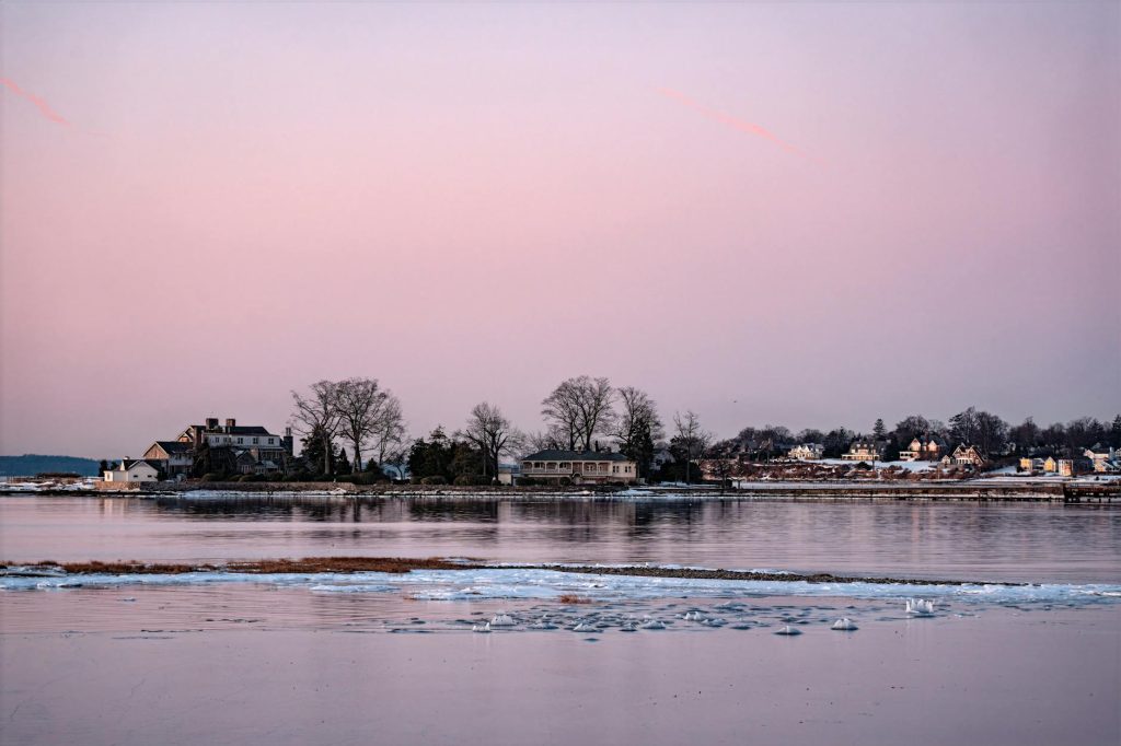Beautiful winter sunrise over icy waters at Cove Island Park, Stamford, Connecticut.