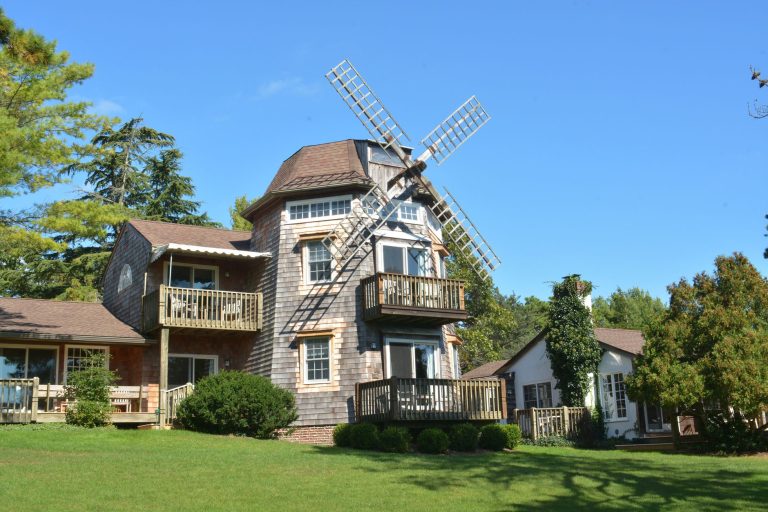 Explore a rustic windmill-style house in a serene Hampton Bays setting for a tranquil getaway.