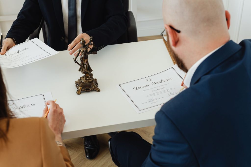 A professional setting with a focus on signing divorce documents in an office environment.